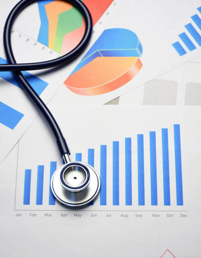 Stethoscope on financial chart, graph paper, financial statistics and business data medical health concept