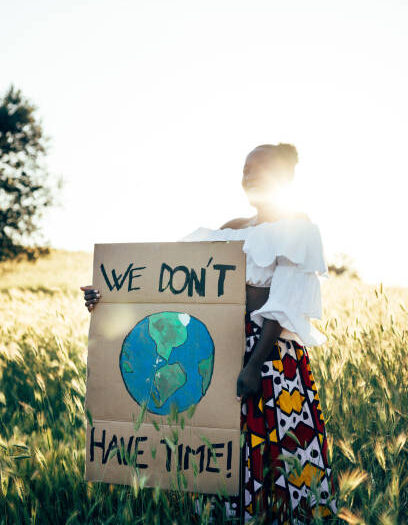 Woman writing a placard, she is fighting for saving environment and protesting for climate changes.