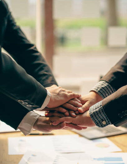 The hands of a team of businessmen joining forces celebrate the concept of unity. A close-up photo of a team working together to make business successful. teamwork business
