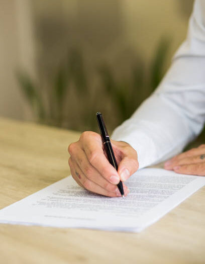 Close up view of businessman hand writing on paper work