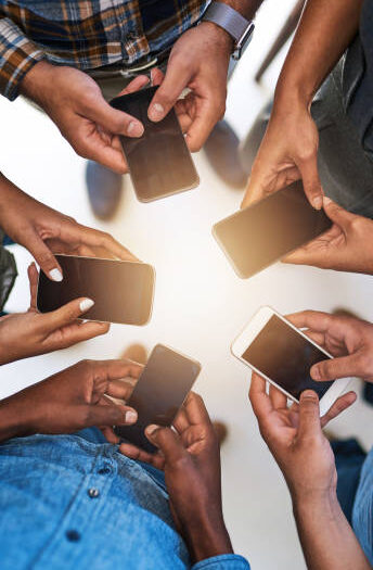 Cropped shot of a group of people using their smart phones in synchronicity